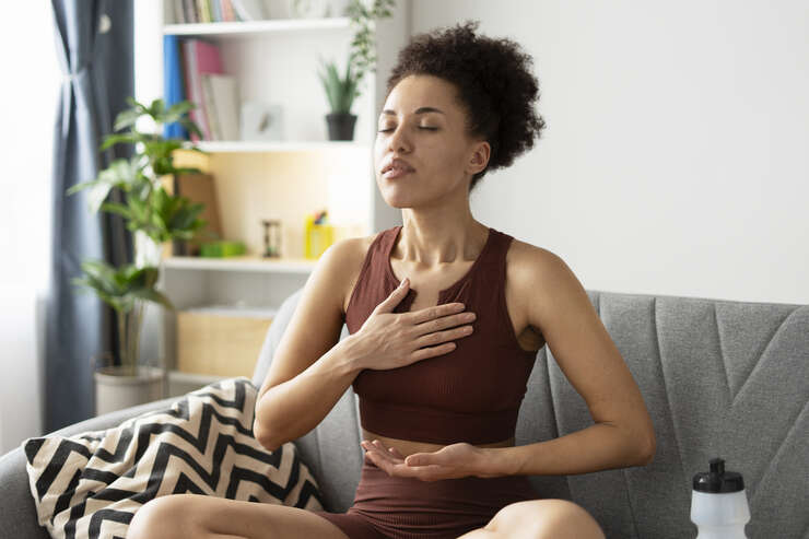 Mulher meditando no sofa